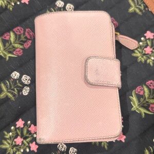 Prada pink wallet.